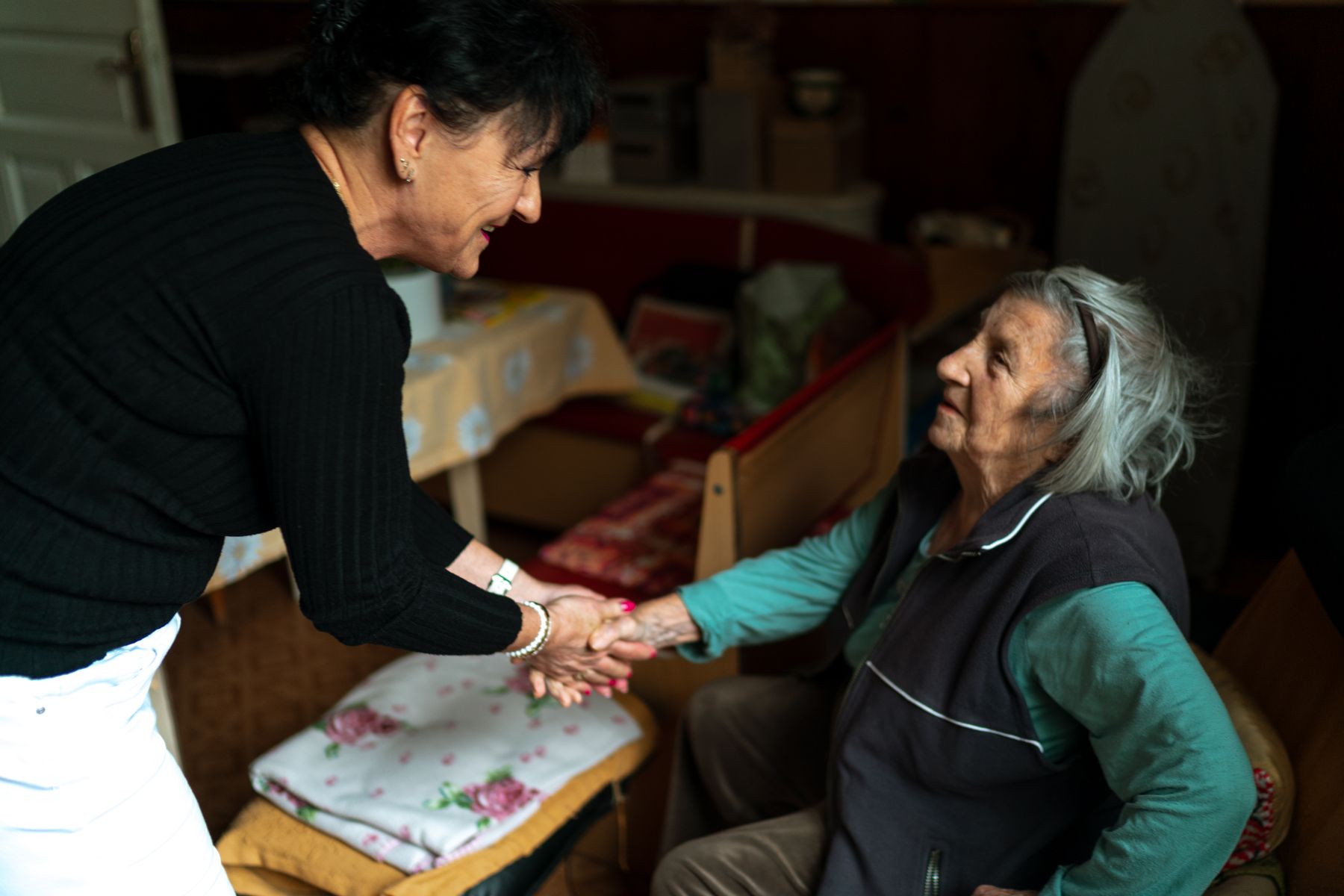 A caregiver sharing a warm moment with an older adult at home